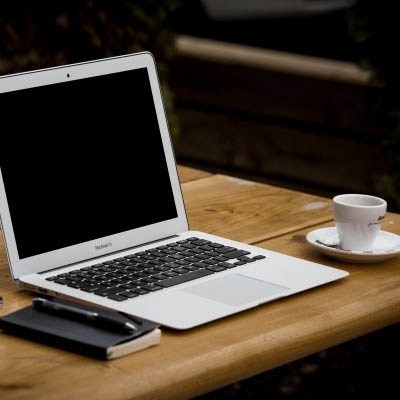 laptop-mobile-phone-notebook-and-coffee-cup-on-wooden-table